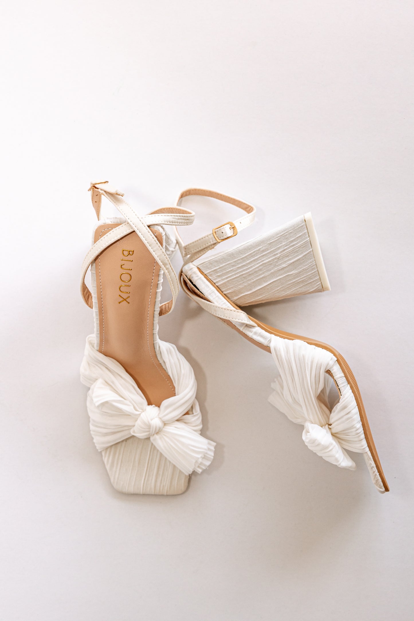 White pleated chiffon fabric heels with peep toe, a bow and block heel 