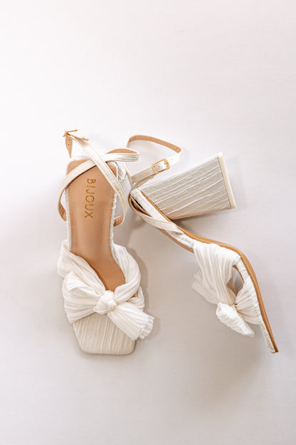 White pleated chiffon fabric heels with peep toe, a bow and block heel 